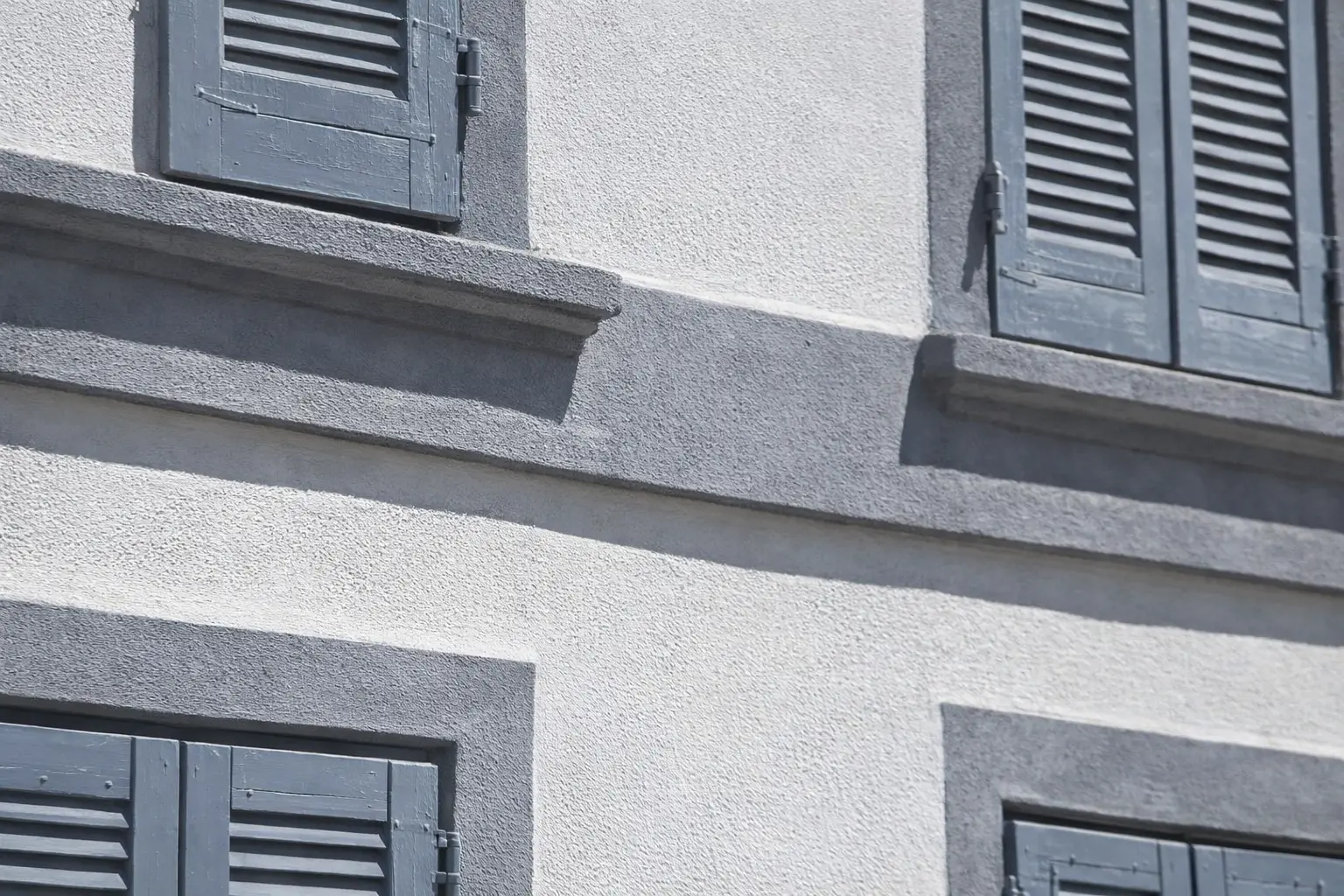 The image shows a detail of cornices and tringcourses of the historic facace insulation of a building in Milan